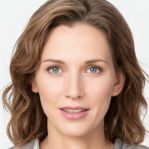 Joyful white young-adult female with medium  brown hair and green eyes