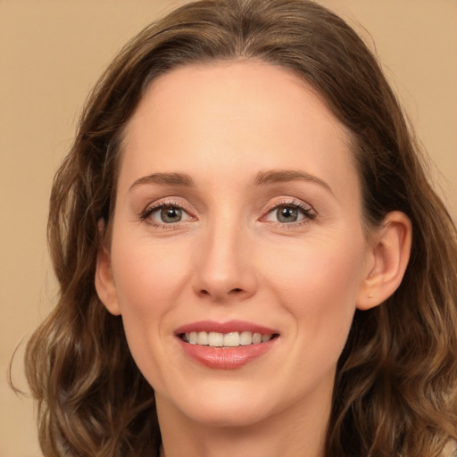 Joyful white young-adult female with long  brown hair and green eyes