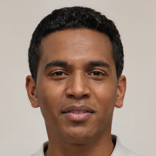 Joyful black young-adult male with short  black hair and brown eyes