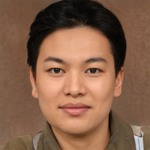 Joyful asian young-adult male with medium  brown hair and brown eyes