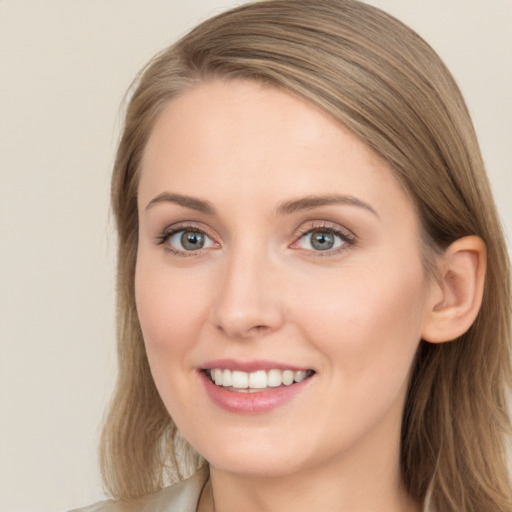 Joyful white young-adult female with long  brown hair and blue eyes