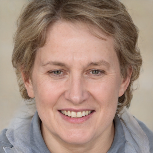 Joyful white adult female with medium  brown hair and blue eyes