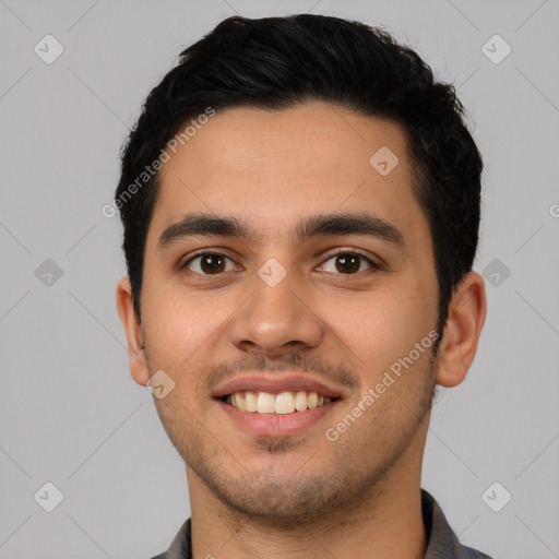 Joyful latino young-adult male with short  black hair and brown eyes