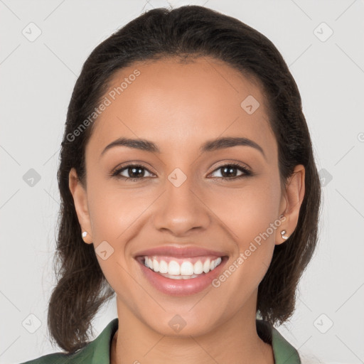 Joyful latino young-adult female with long  brown hair and brown eyes