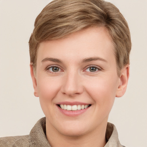 Joyful white young-adult female with short  brown hair and grey eyes