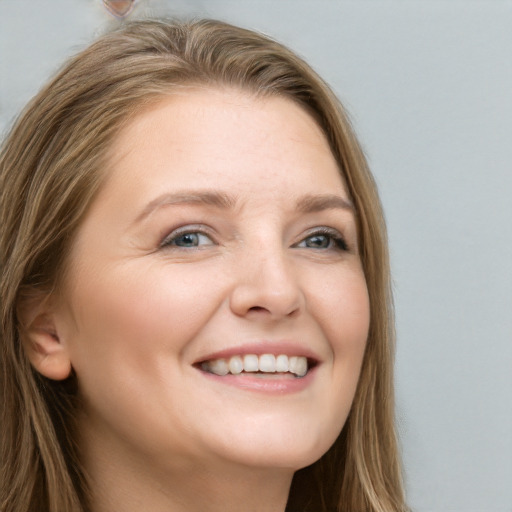 Joyful white young-adult female with long  brown hair and grey eyes