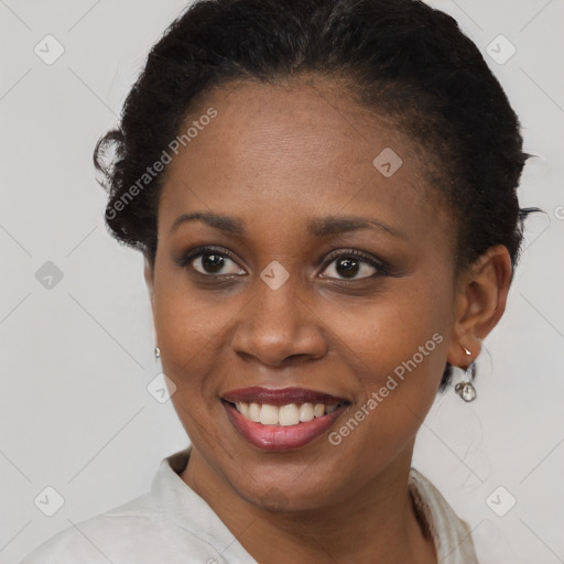 Joyful black young-adult female with short  brown hair and brown eyes