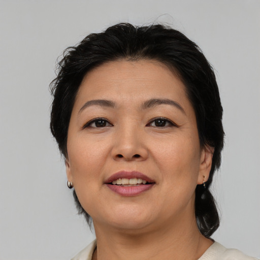 Joyful asian adult female with medium  brown hair and brown eyes