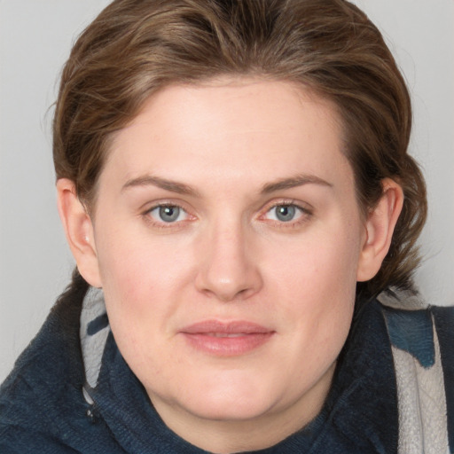 Joyful white young-adult female with medium  brown hair and blue eyes