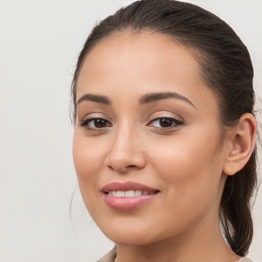 Joyful white young-adult female with long  brown hair and brown eyes