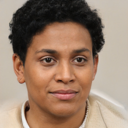 Joyful latino young-adult female with short  brown hair and brown eyes