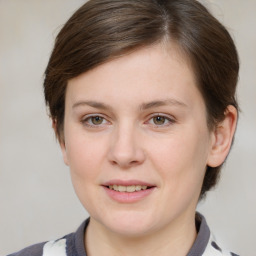 Joyful white young-adult female with medium  brown hair and grey eyes