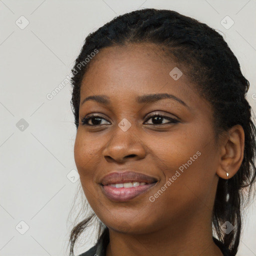 Joyful black young-adult female with long  black hair and brown eyes