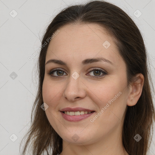 Joyful white young-adult female with long  brown hair and grey eyes