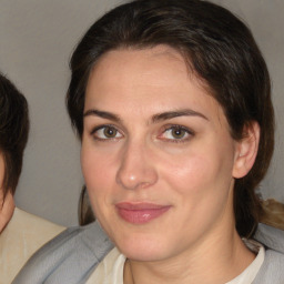 Joyful white adult female with medium  brown hair and brown eyes