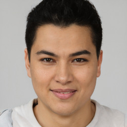 Joyful latino young-adult male with short  brown hair and brown eyes