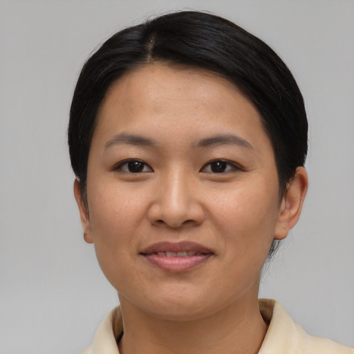 Joyful asian young-adult female with short  black hair and brown eyes