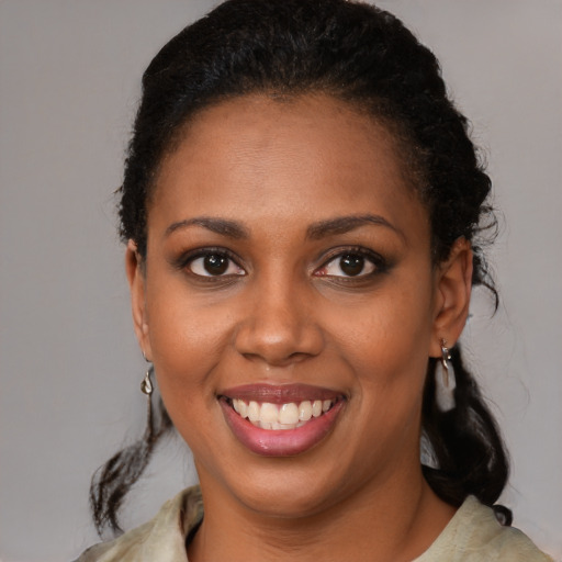 Joyful black young-adult female with medium  brown hair and brown eyes