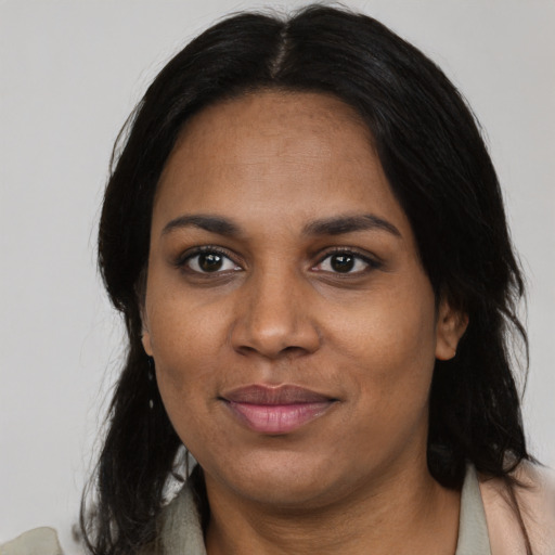 Joyful black adult female with medium  black hair and brown eyes