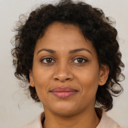 Joyful black adult female with medium  brown hair and brown eyes