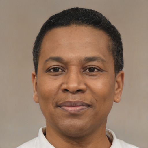 Joyful latino adult male with short  black hair and brown eyes