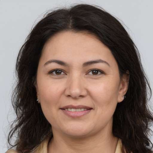 Joyful white adult female with medium  brown hair and brown eyes