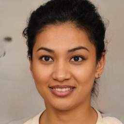 Joyful latino young-adult female with medium  brown hair and brown eyes