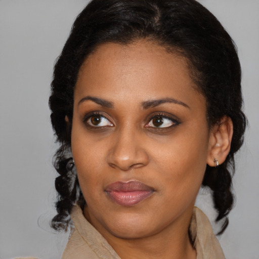 Joyful black young-adult female with medium  brown hair and brown eyes
