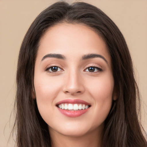 Joyful white young-adult female with long  brown hair and brown eyes