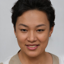 Joyful asian young-adult female with short  brown hair and brown eyes