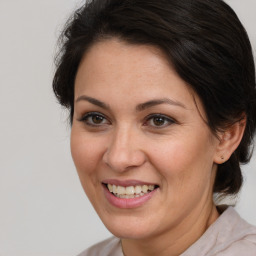 Joyful white adult female with medium  brown hair and brown eyes