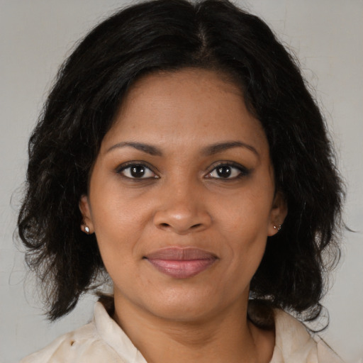 Joyful black young-adult female with medium  brown hair and brown eyes