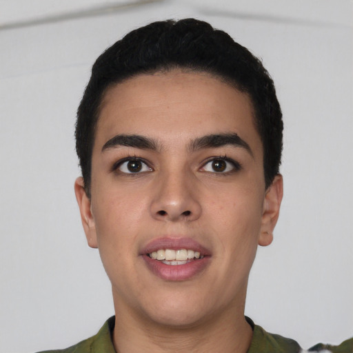 Joyful latino young-adult male with short  black hair and brown eyes