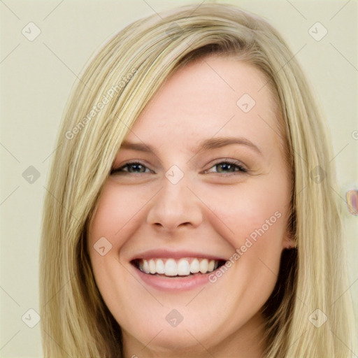 Joyful white young-adult female with long  brown hair and blue eyes