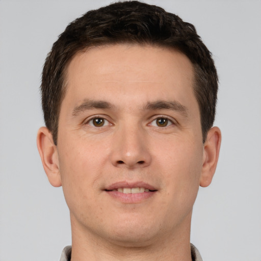 Joyful white young-adult male with short  brown hair and brown eyes