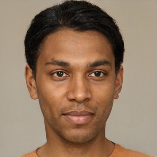 Joyful black young-adult male with short  black hair and brown eyes
