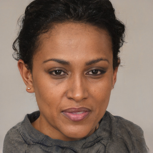 Joyful black adult female with short  brown hair and brown eyes