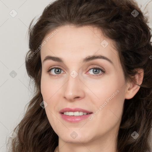 Joyful white young-adult female with long  brown hair and green eyes