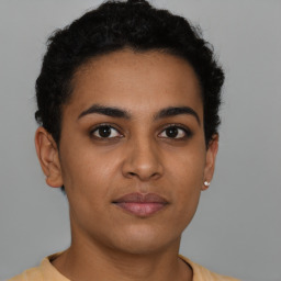 Joyful latino young-adult female with short  brown hair and brown eyes