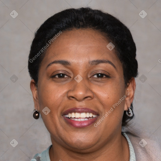 Joyful black adult female with short  brown hair and brown eyes