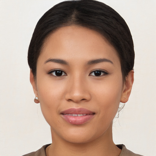 Joyful asian young-adult female with short  black hair and brown eyes