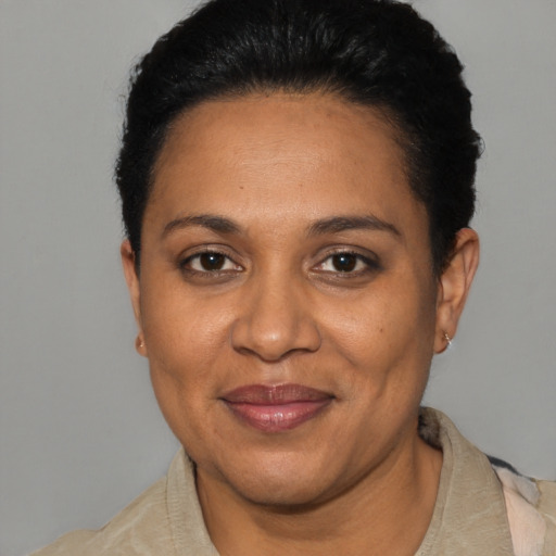 Joyful black adult female with short  black hair and brown eyes