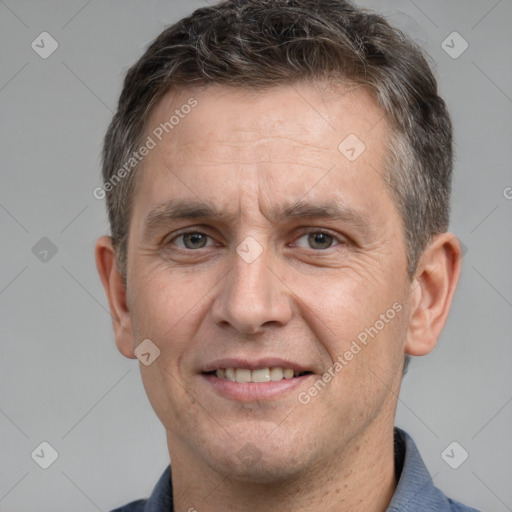 Joyful white adult male with short  brown hair and brown eyes