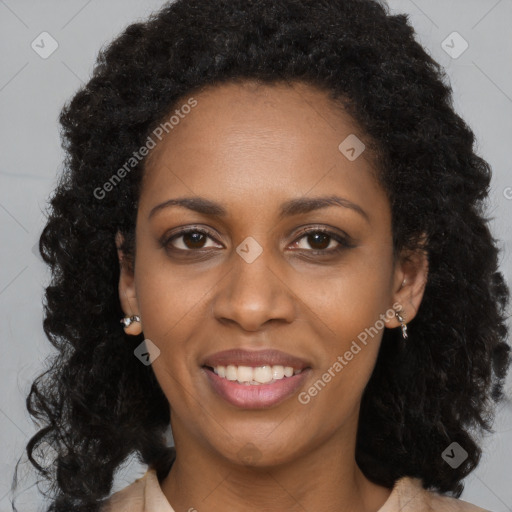 Joyful black young-adult female with long  black hair and brown eyes