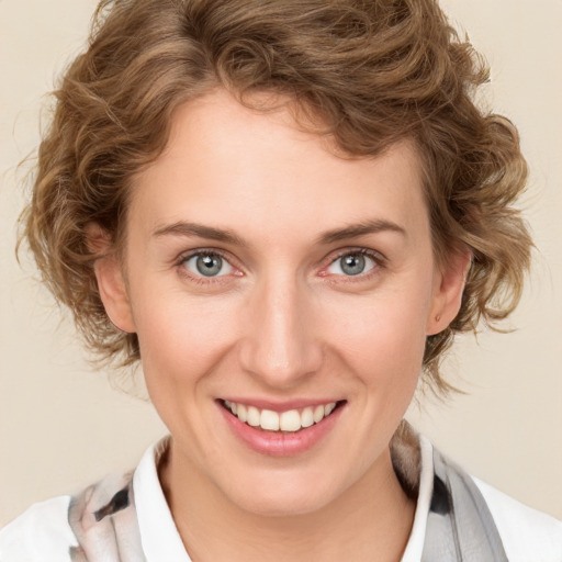 Joyful white young-adult female with medium  brown hair and blue eyes