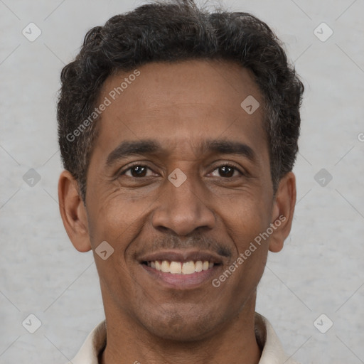 Joyful latino adult male with short  brown hair and brown eyes