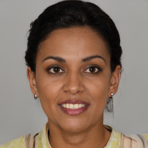 Joyful latino young-adult female with short  brown hair and brown eyes