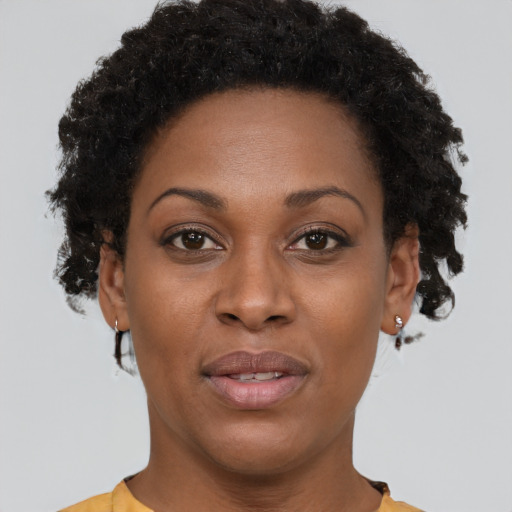 Joyful black adult female with short  brown hair and brown eyes