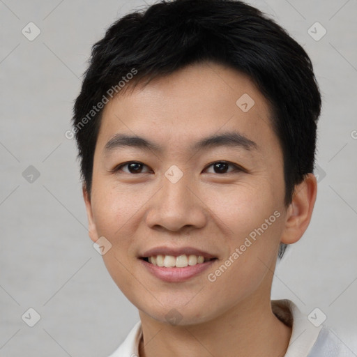 Joyful asian young-adult male with short  black hair and brown eyes