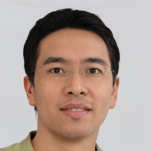 Joyful asian young-adult male with short  black hair and brown eyes